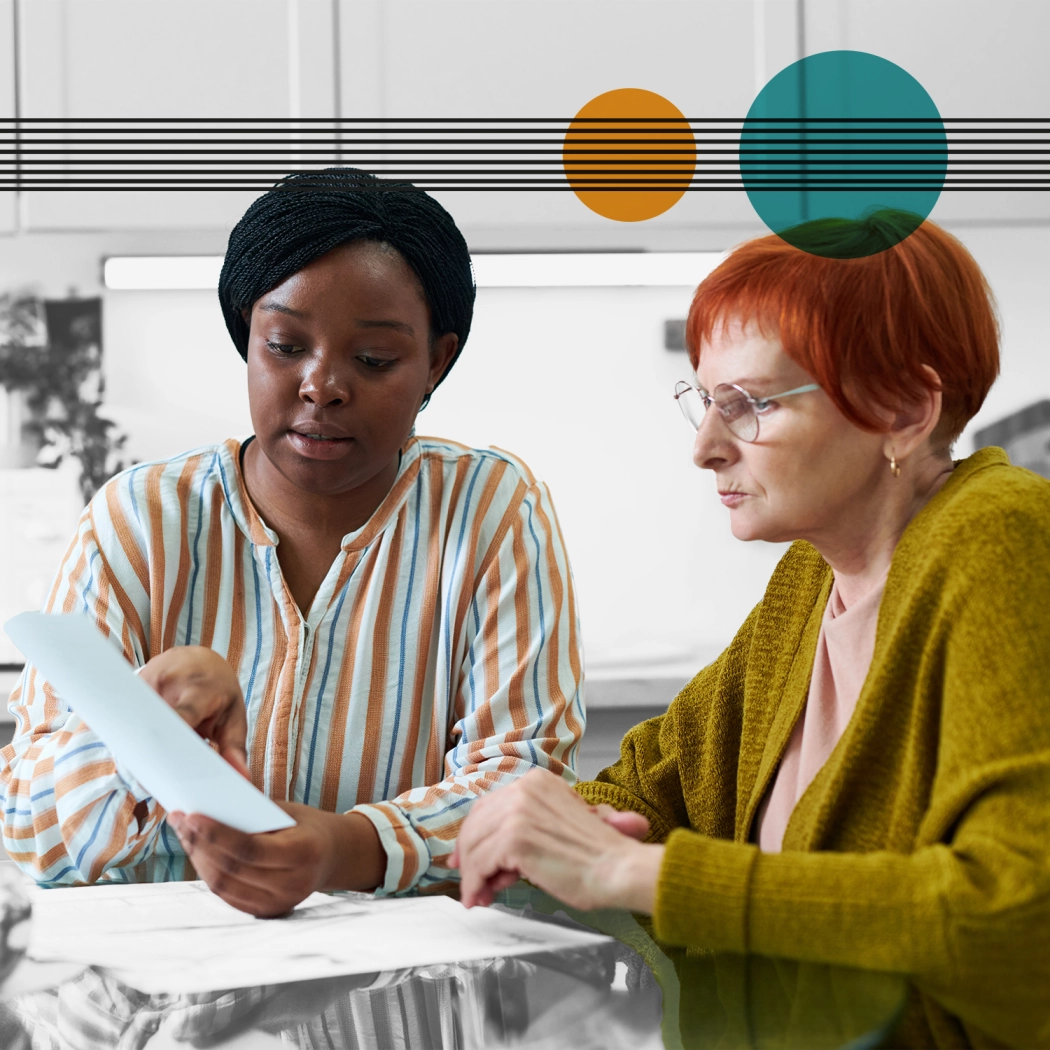 Young lady helping elderly lady with an application