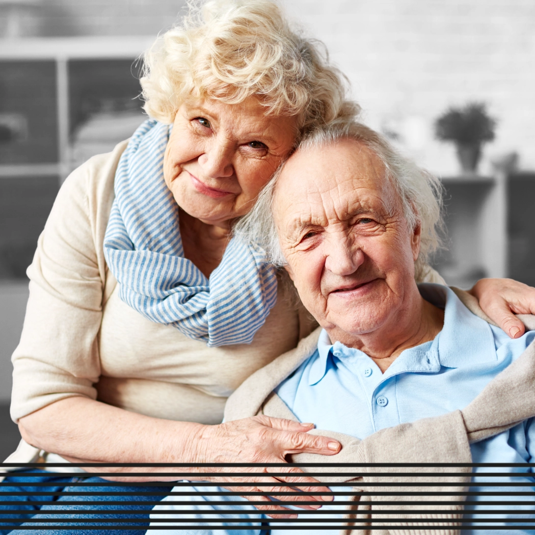 Elderly couple hugging and smiling