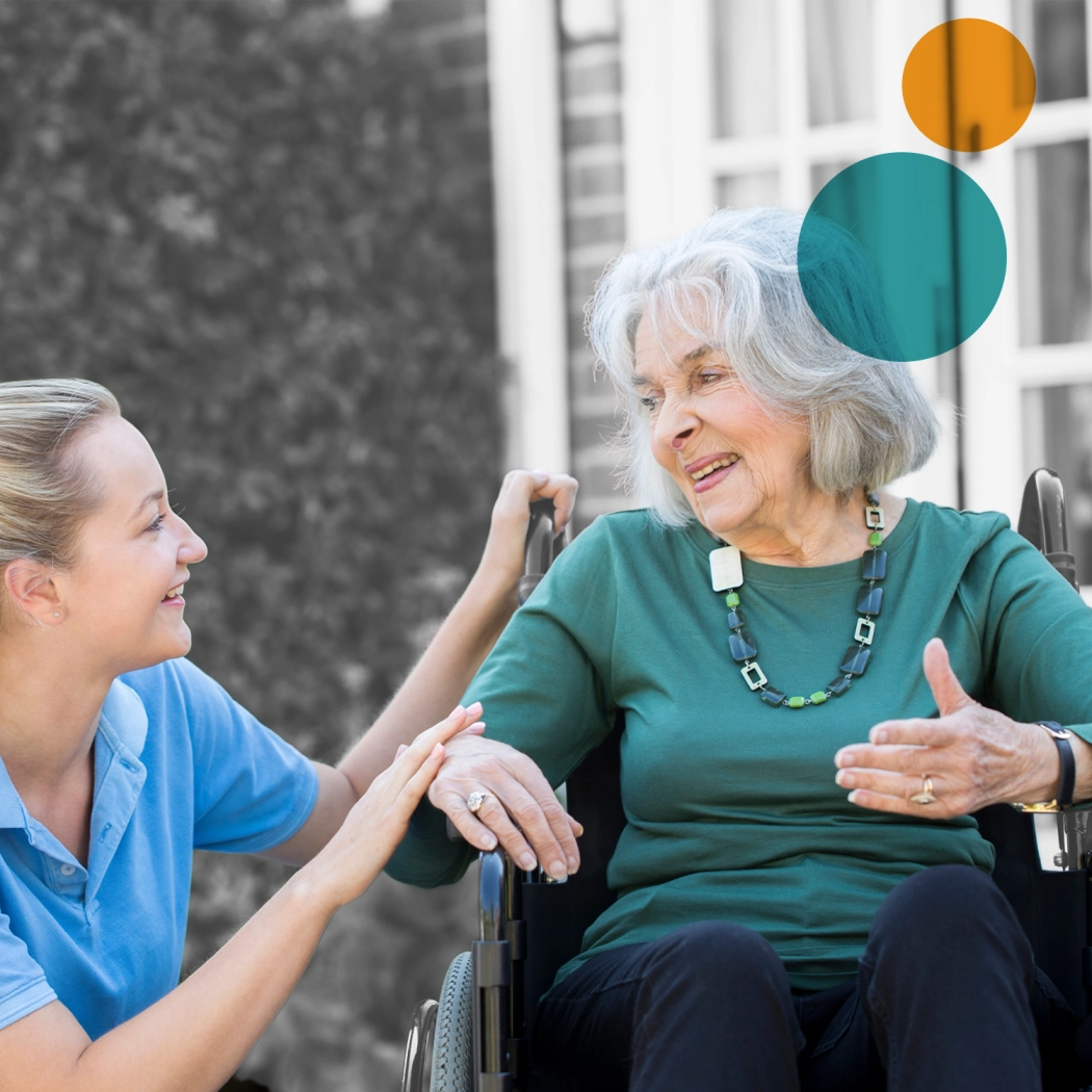 Carer next to elderly lady in wheelchair