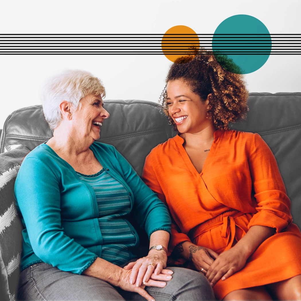 Elderly lady chatting to younger lady on couch