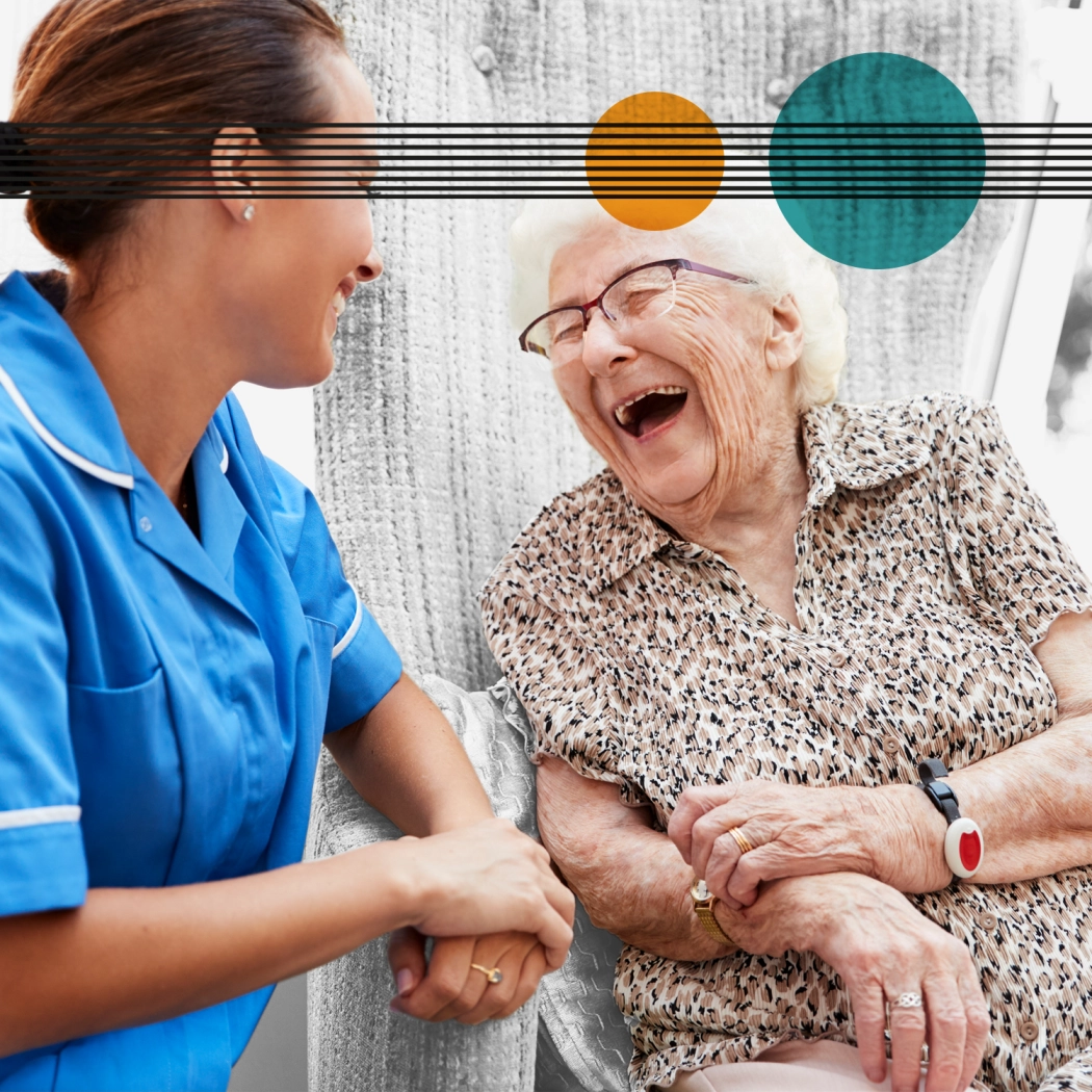 Carer laughing with elderly lady