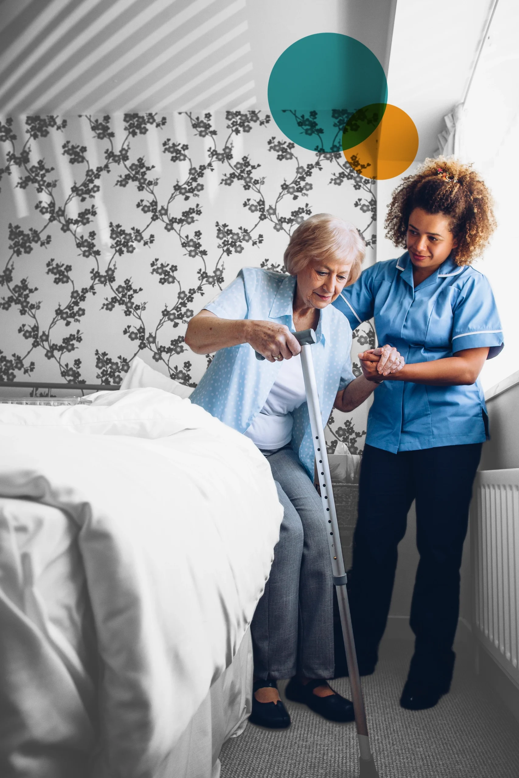 Female carer helping an elderly woman get out of bed